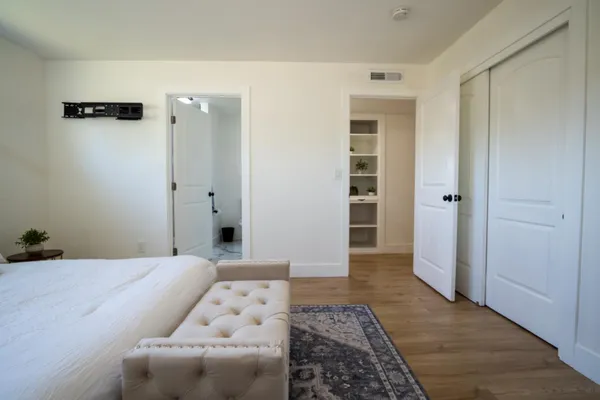 a bedroom with a bed and a couch