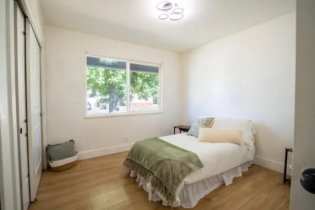 a bedroom with a bed and a window