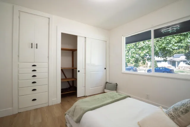 a bedroom with a bed and a window