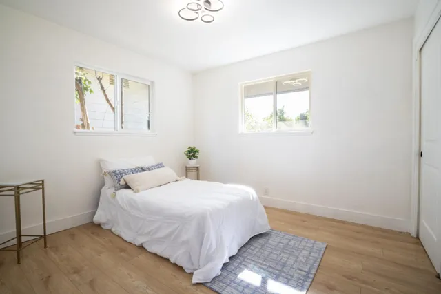 a bedroom with a bed and a window