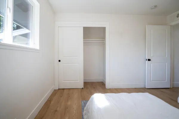 a bedroom with a bed and a window