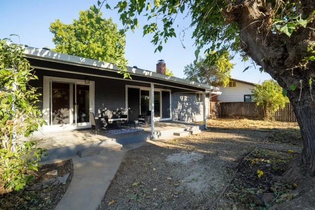 a view of a house with backyard porch and sitting area