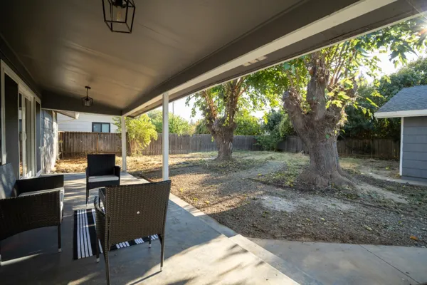 a view of a porch with furniture and garden