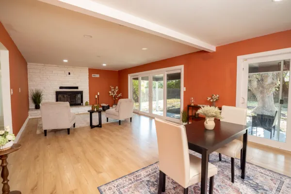 a living room with furniture and a dining table with kitchen view