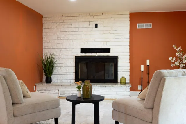 a living room with furniture and a fireplace
