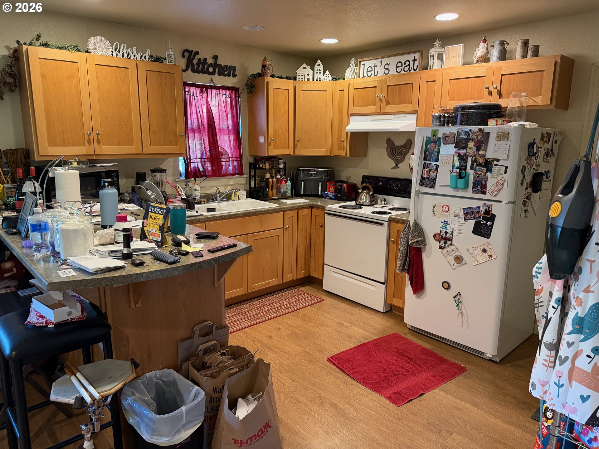 33802 Market Road Creswell, OR 97426 - Photo 20 of 30 a kitchen with stainless steel appliances kitchen island granite countertop a sink dishwasher and a refrigerator with wooden floor