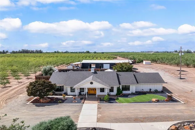 an aerial view of a house with a garden space and ocean view