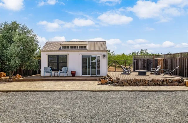 a view of a workspace with furniture and a flat screen tv