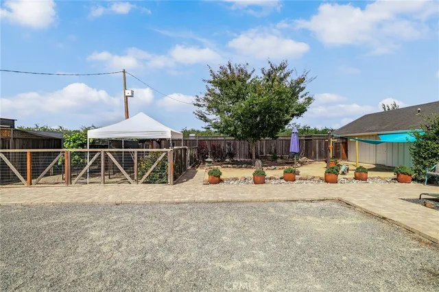 a view of a yard with wooden fence