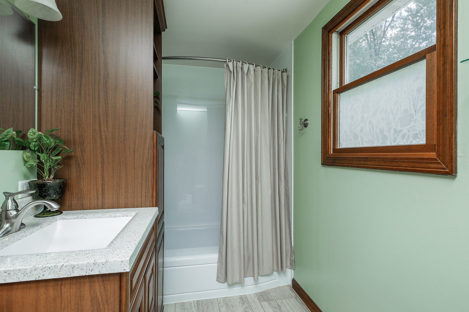 6N476 Thorn Road Hanover Park, IL 60133 - Photo 11 of 35 a bathroom with a granite countertop sink and a mirror