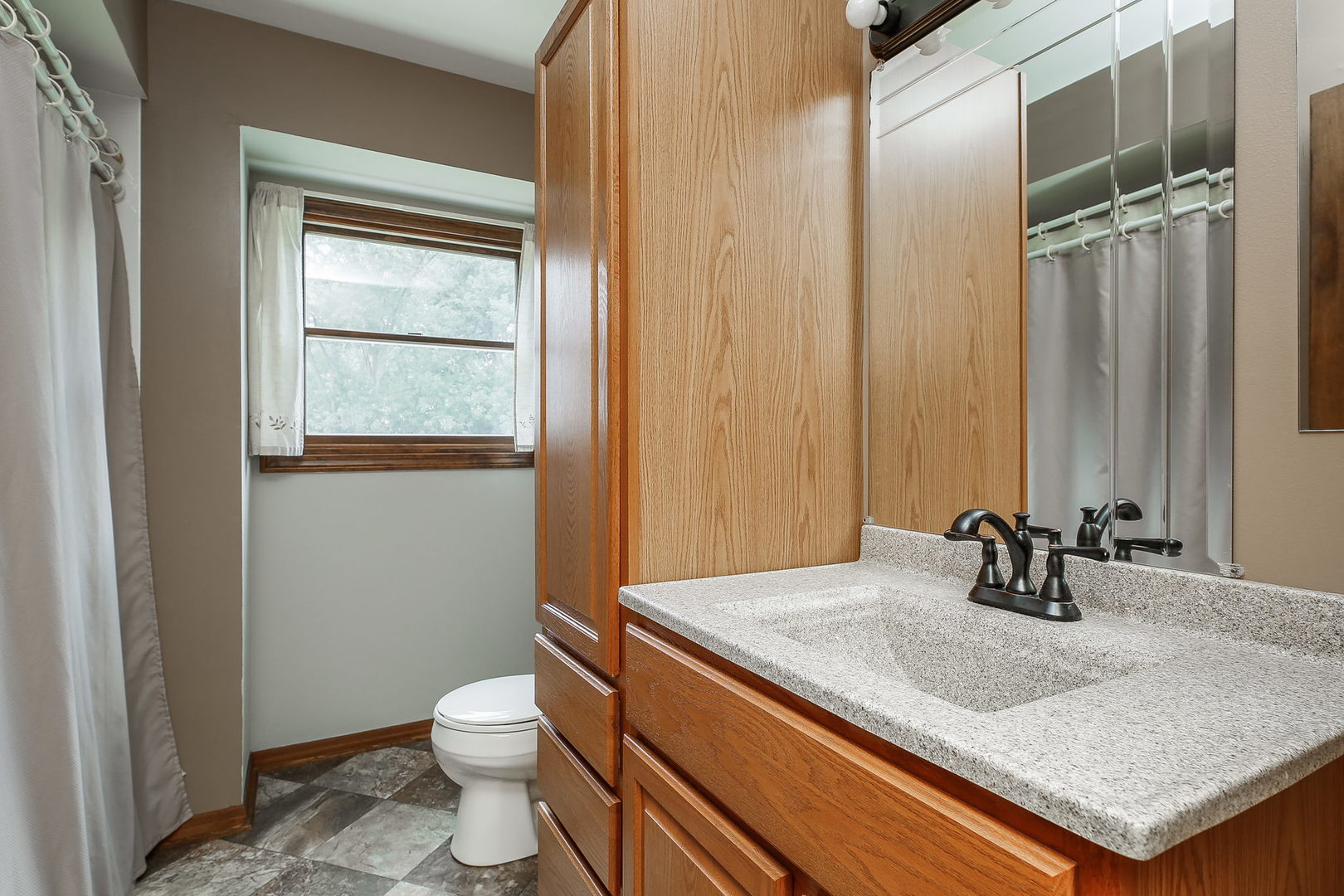6N476 Thorn Road Hanover Park, IL 60133 - Photo 17 of 35 a bathroom with a granite countertop sink toilet and mirror