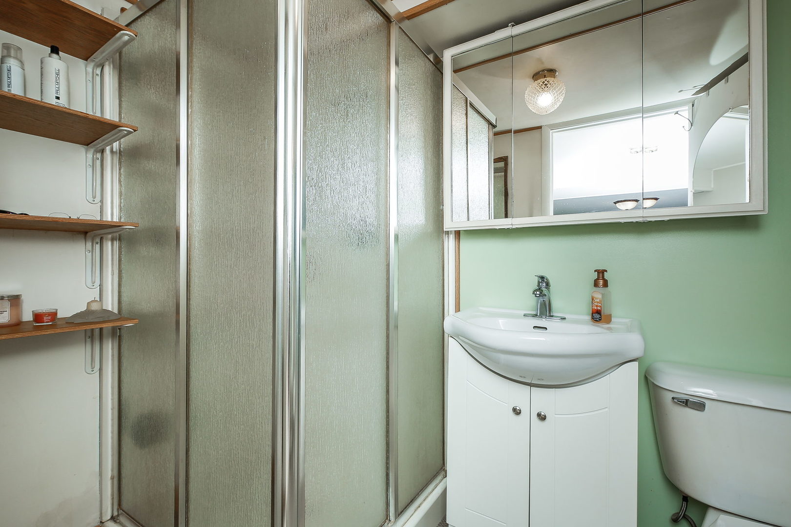 6N476 Thorn Road Hanover Park, IL 60133 - Photo 21 of 35 a bathroom with a sink a toilet and mirror