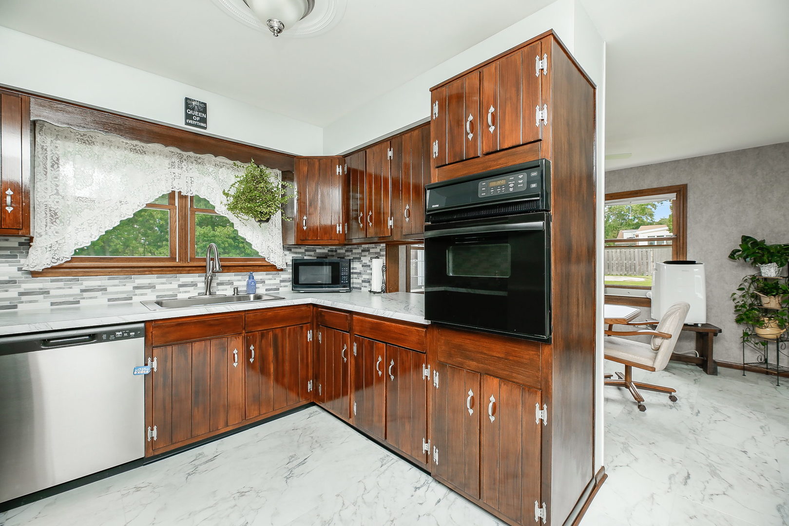 6N476 Thorn Road Hanover Park, IL 60133 - Photo 3 of 35 a kitchen with stainless steel appliances granite countertop a stove and a sink