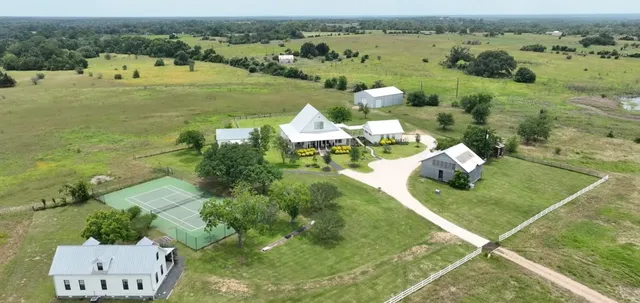 an aerial view of a houses with outdoor space