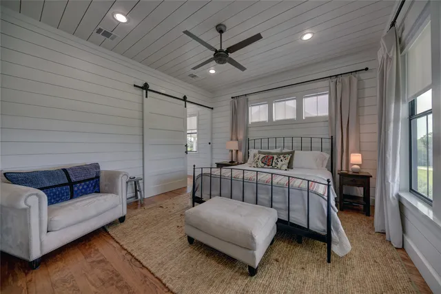 a bedroom with a bed couch and window