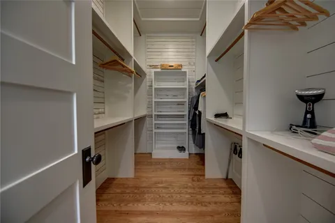 a bedroom with a bed a couch and dresser