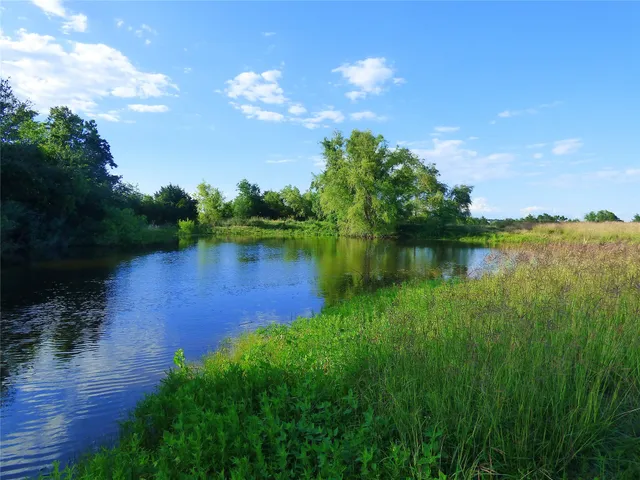 a view of a lake with a big yard