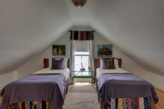 a bedroom with a bed and large windows