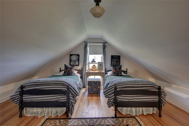a bedroom with two beds and a chandelier
