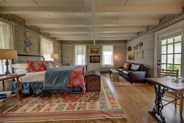 a bedroom with bed and window
