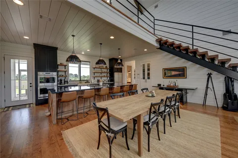 a living room with furniture a chandelier and a rug