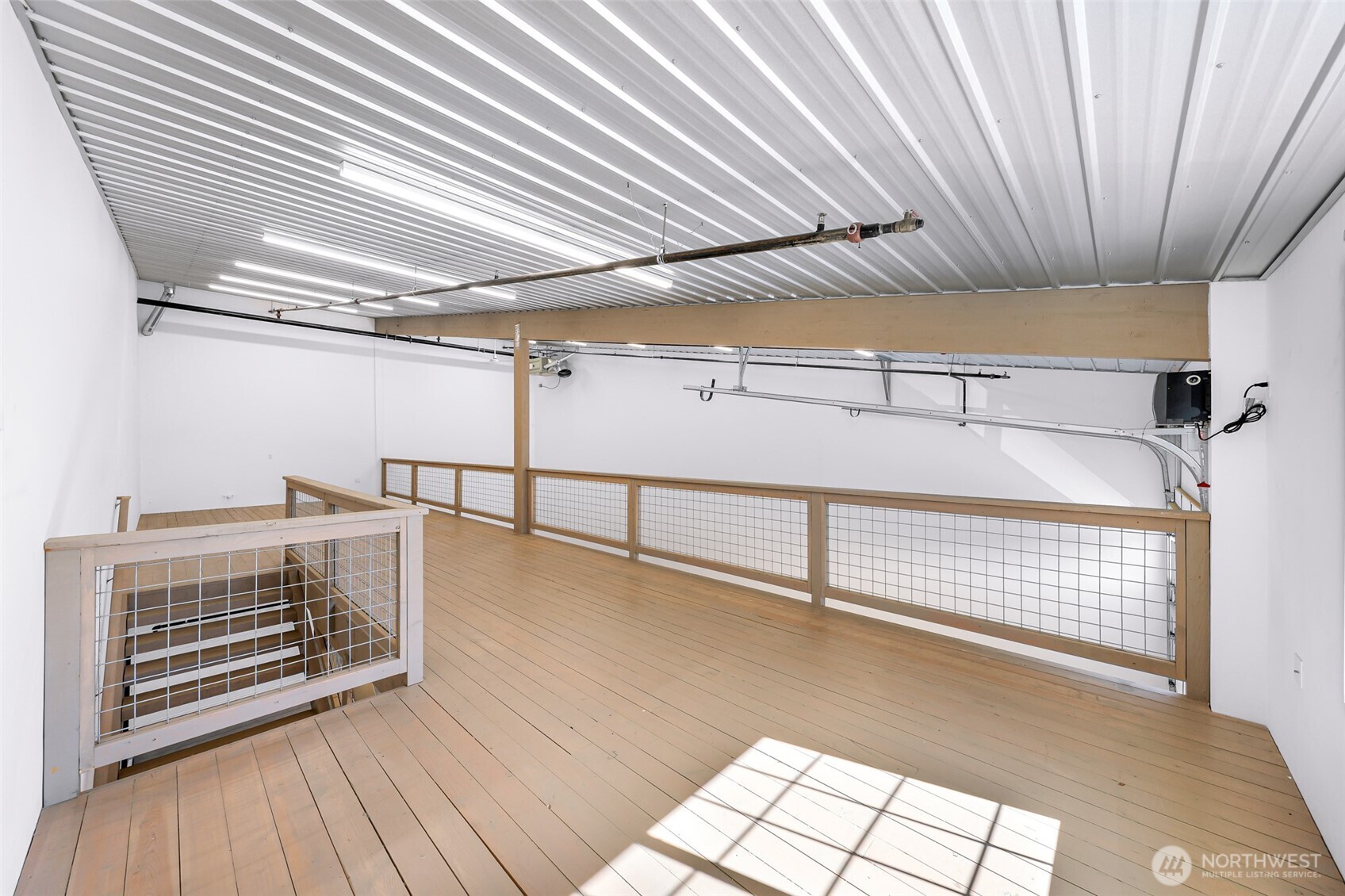 1957 Baltic Way, Unit 111 Ferndale, WA 98248 - Photo 25 of 27 a view of an empty room with wooden floor