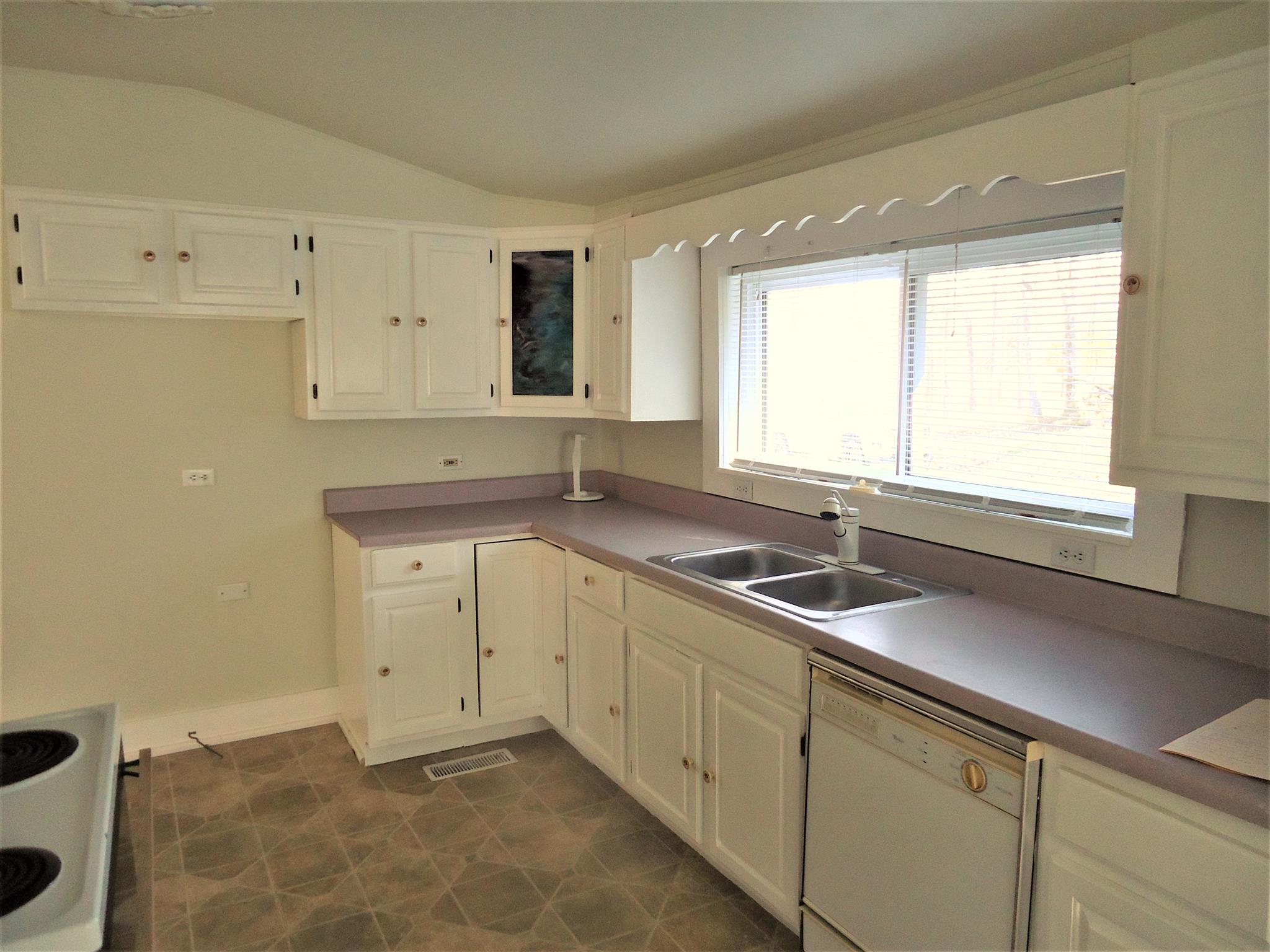 8101 Prospect Road Prospect, TN 38477 - Photo 19 of 26 a kitchen with granite countertop white cabinets and a sink