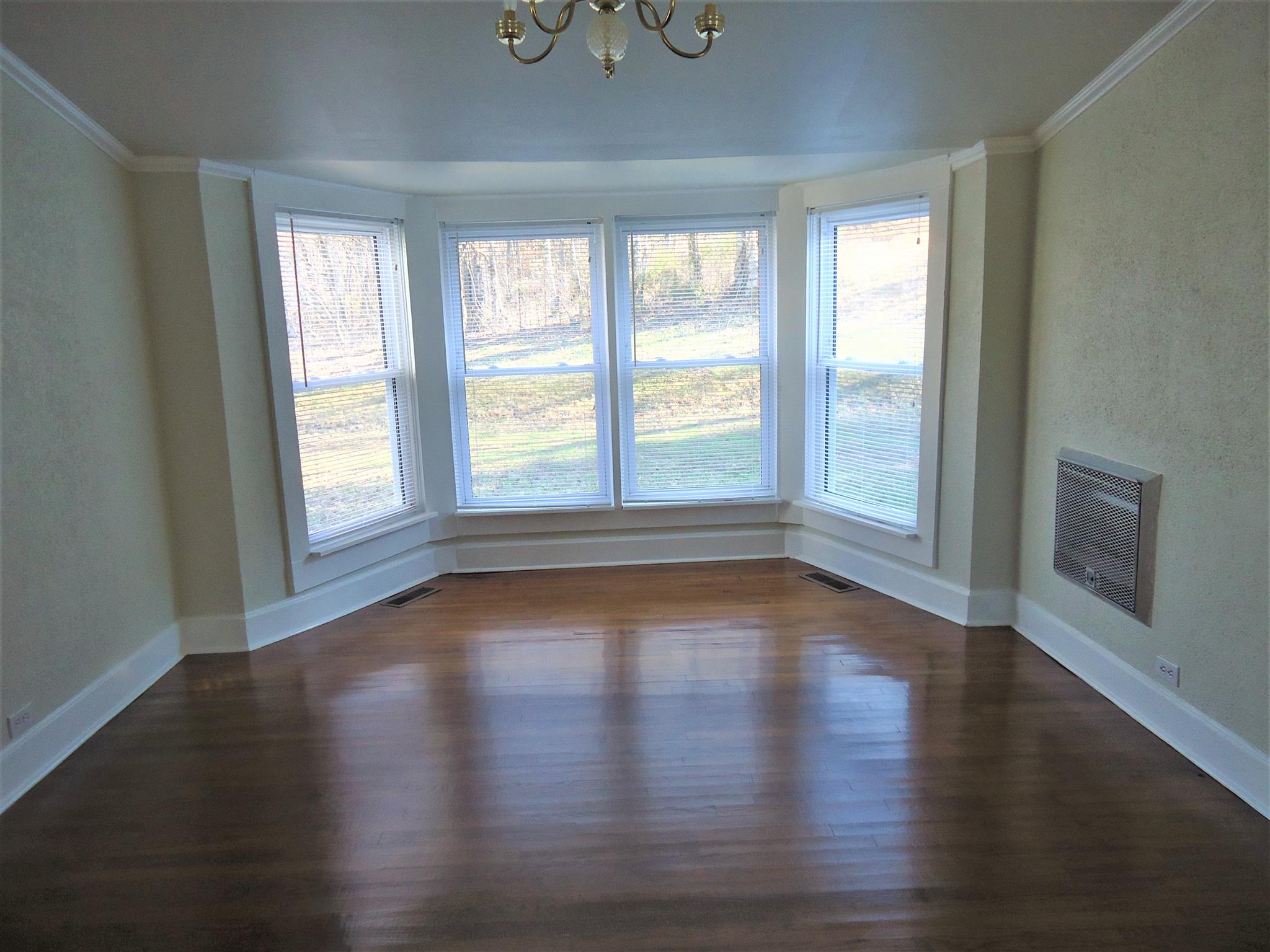 8101 Prospect Road Prospect, TN 38477 - Photo 21 of 26 a view of an empty room with wooden floor and a window