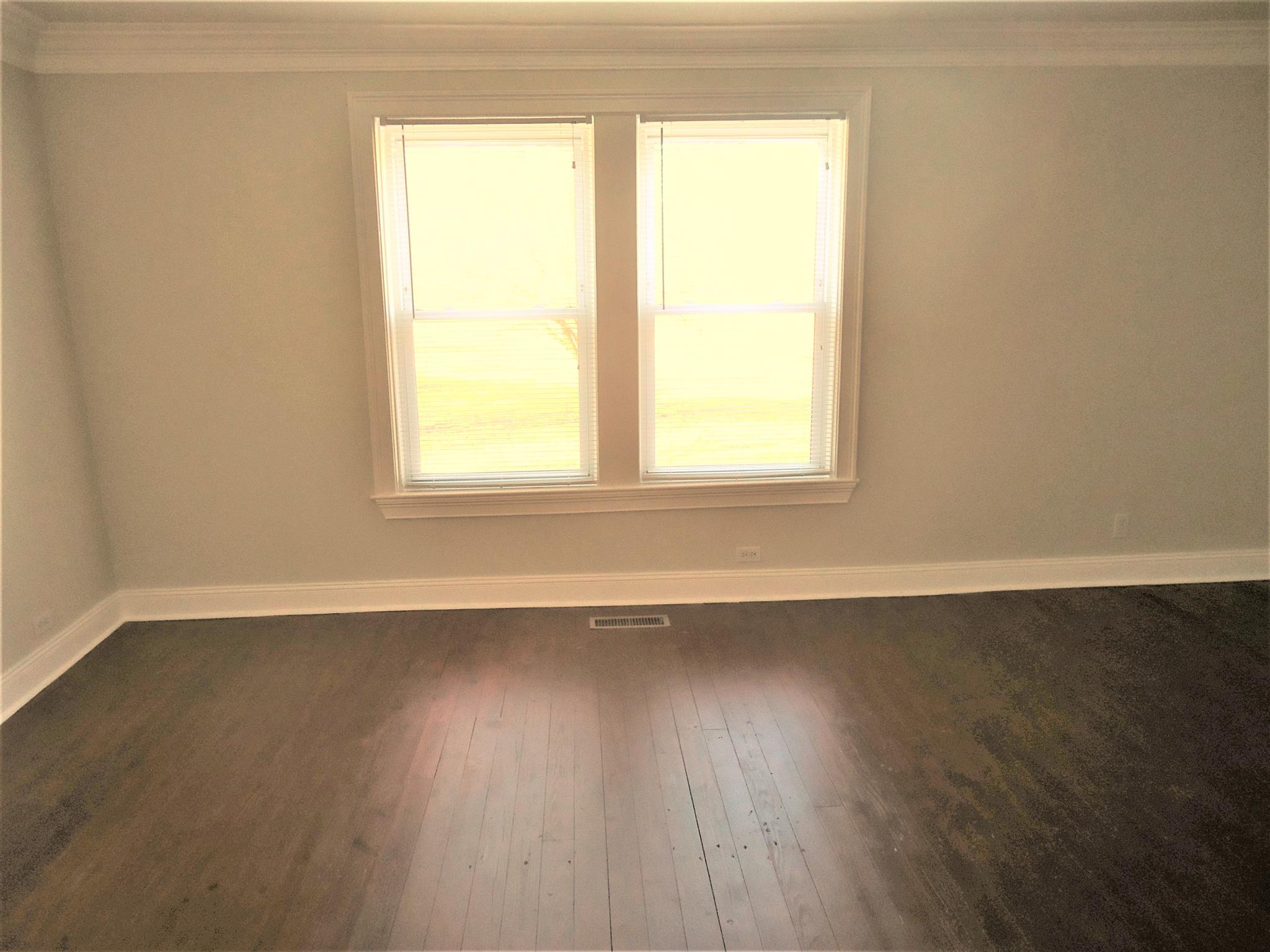 8101 Prospect Road Prospect, TN 38477 - Photo 24 of 26 an empty room with wooden floor and a window