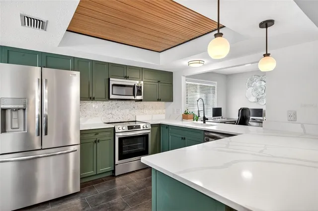 a kitchen with cabinets and stainless steel appliances