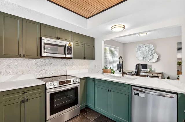 a kitchen with a sink stove and microwave