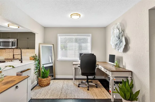 a workspace with furniture and a window