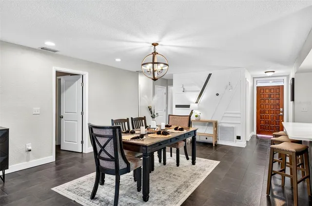 a dining room with furniture window and wooden floor