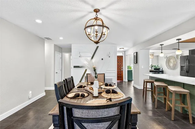 a living room with furniture a clock and a chandelier