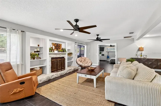 a living room with furniture a fireplace and a window