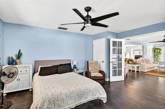 a bedroom with a bed and wooden floor