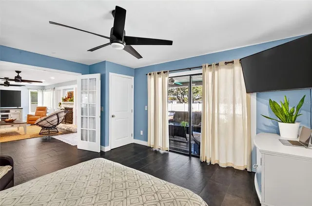 a bedroom with furniture and a large window