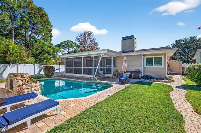 a view of a house with backyard sitting area and garden