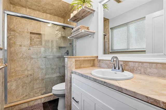 a bathroom with a sink toilet and shower