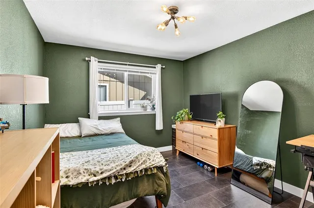 a bedroom with a bed and a chandelier