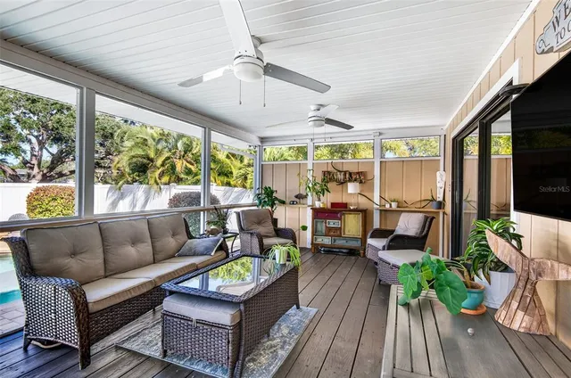 a living room with furniture and a floor to ceiling window