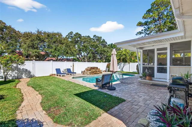 a view of a backyard with sitting area