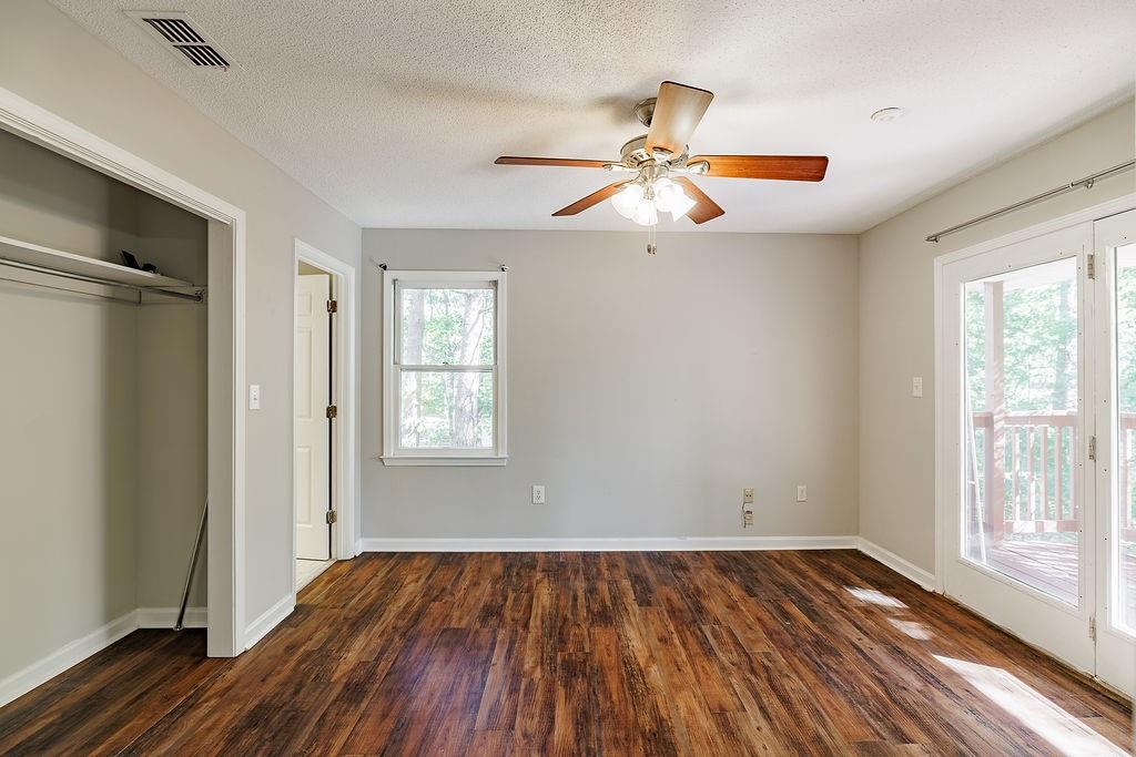 345 Research Drive, Unit 330 Athens, GA 30605 - Photo 14 of 31 wooden floor in an empty room with a window