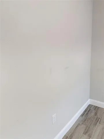 a view of an empty room and wooden floor