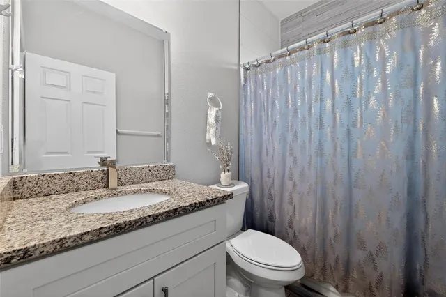 a spacious bathroom with a double vanity sink and a mirror