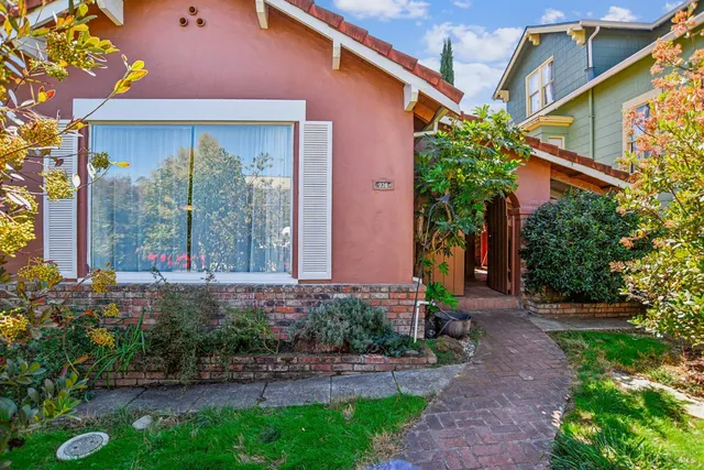 a front view of a house with garden