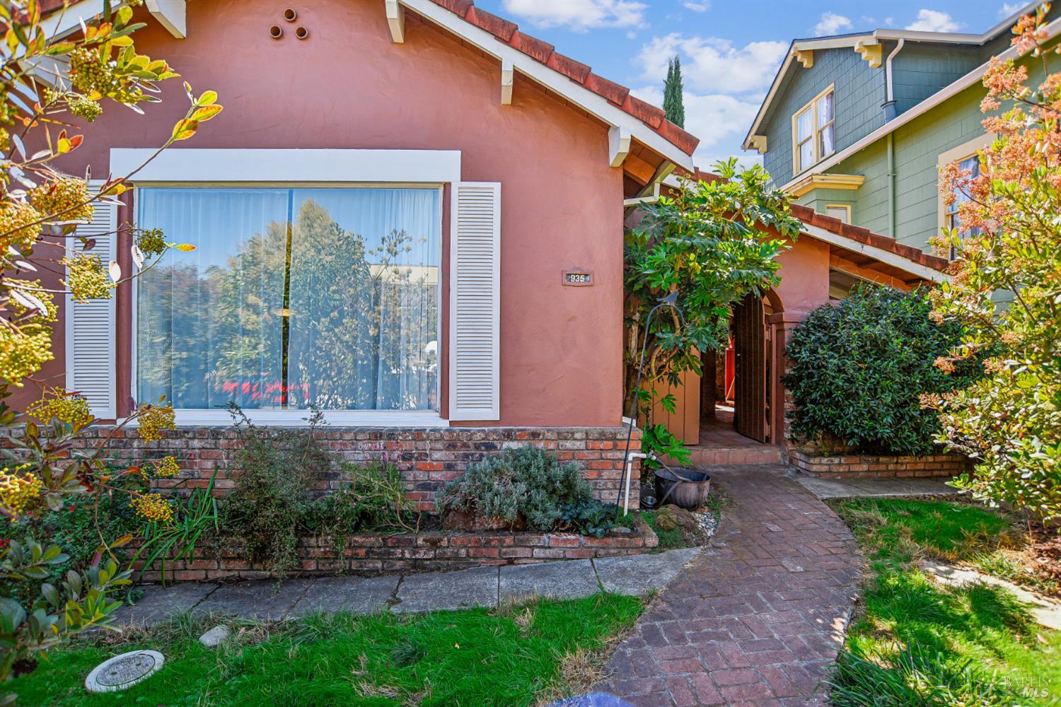 a front view of a house with garden