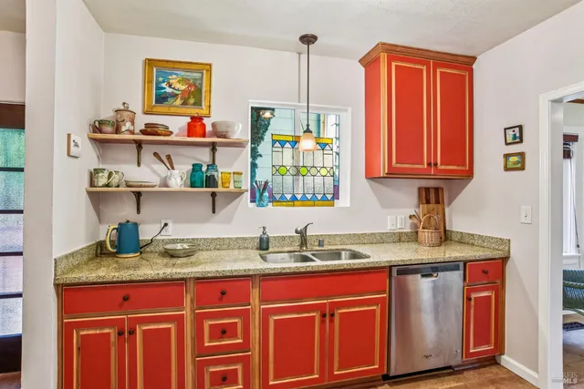 a kitchen with stainless steel appliances granite countertop a sink and a wooden cabinets