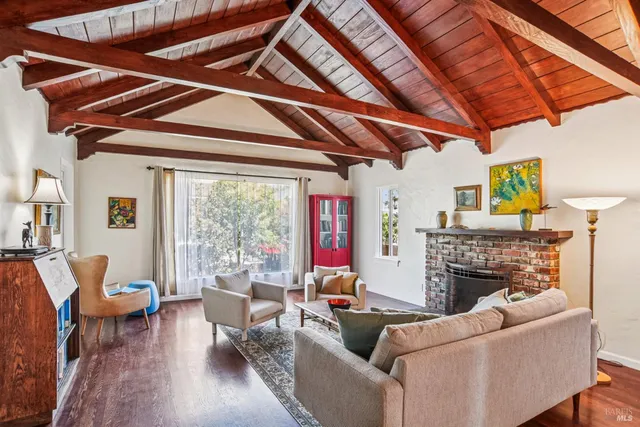 a living room with fireplace furniture and a fireplace