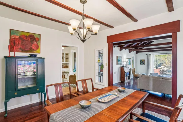 a view of a dining room with furniture wooden floor and a chandelier